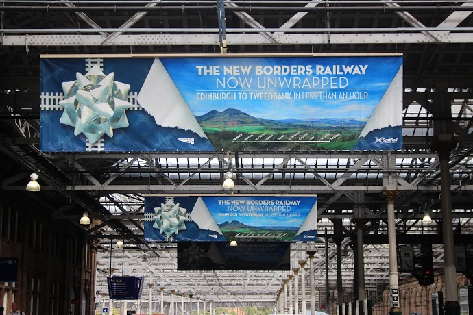 Borders Railway banners hang from Waverley station roof